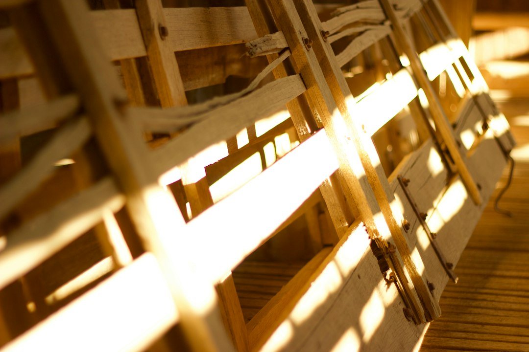 a row of wooden chairs sitting on top of a wooden floor